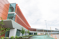 Exterior view of the airport terminal building with red panel facade