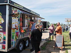 Travelers lined up at a food truck outside the terminal