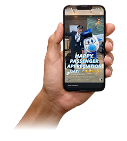 Hand holding a phone displaying a social media post about "Passenger Appreciation Day"