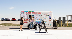"Kool Breze" food truck parked outside with customers ordering