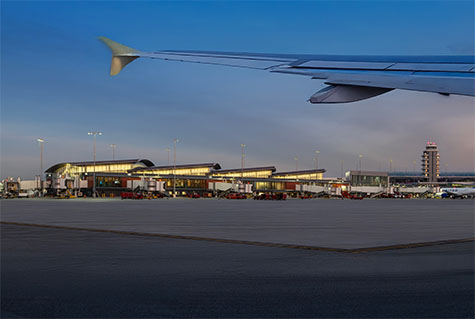 Exterior of Concourse A with a wing of a plane in the foreground